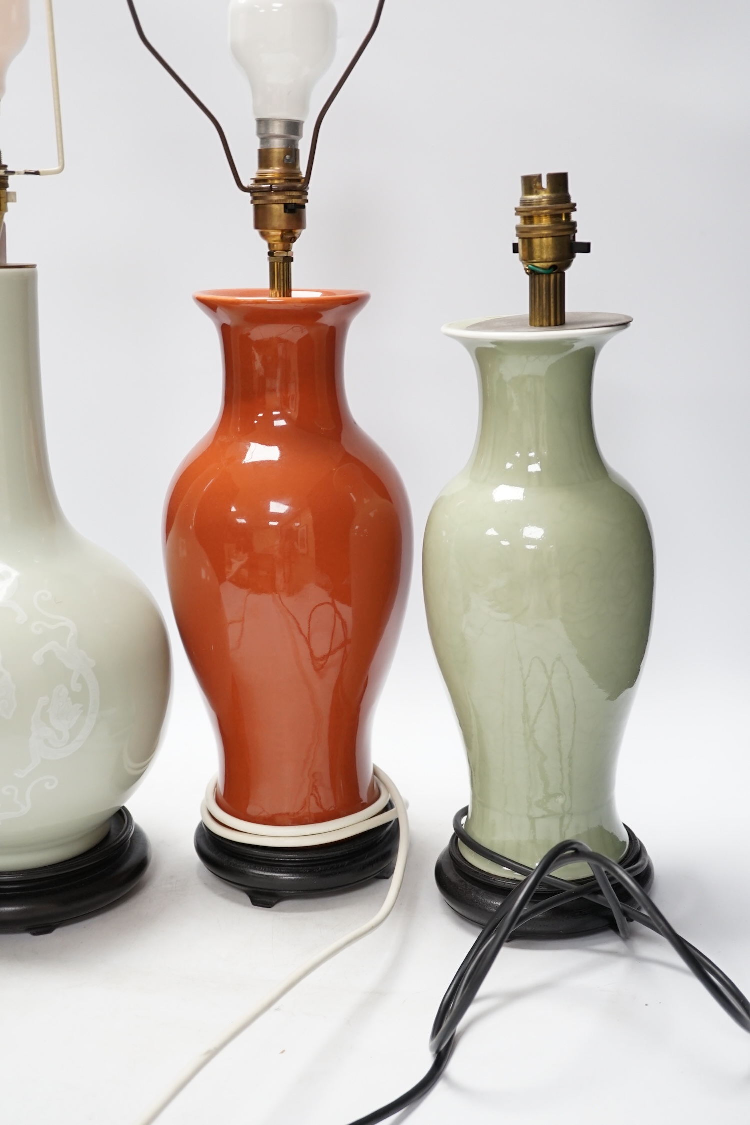 Three Chinese monochrome porcelain lamp bases, 20th century, tallest 38cm high